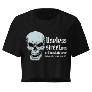 Front view of a black women’s crop top with a large skull graphic and white text on the chest